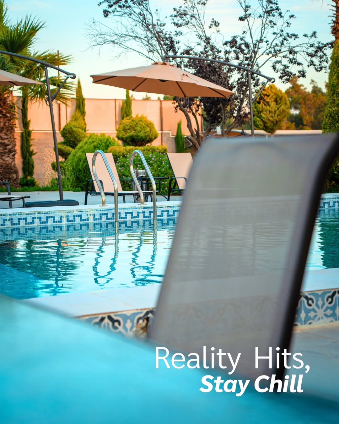 The RETALISA pool at golden hour with empty loungers waiting
